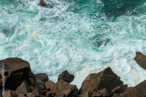 Aerial View of Waves Crashing Against Rocks