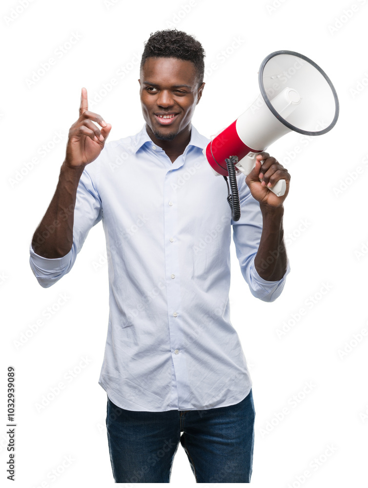 Young african american man holding megaphone surprised with an idea or question pointing finger with happy face, number one Young african american man holding megaphone surprised with an idea or question pointing finger with happy face, number one