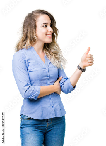 Beautiful young blonde business woman over isolated background Looking proud, smiling doing thumbs up gesture to the side