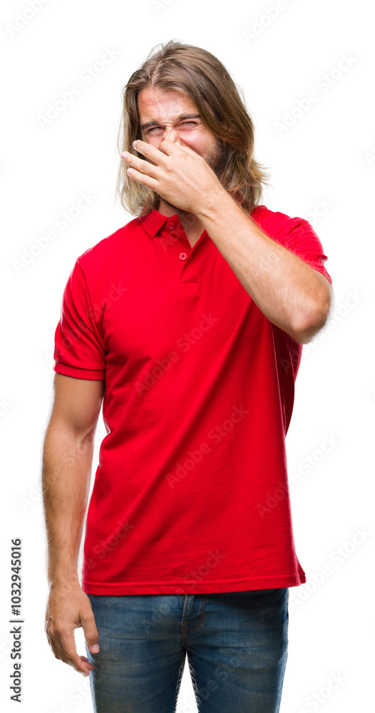 Young handsome man with long hair over isolated background smelling something stinky and disgusting, intolerable smell, holding breath with fingers on nose. Bad smells concept. Young handsome man with long hair over isolated background smelling something stinky and disgusting, intolerable smell, holding breath with fingers on nose. Bad smells concept.