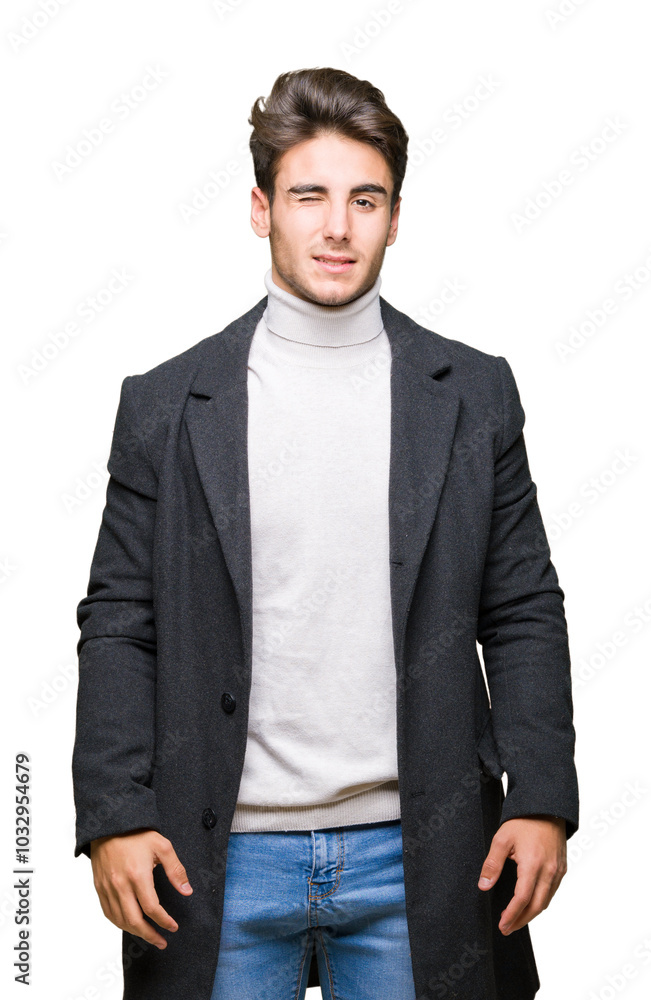 Fototapeta premium Young elegant man wearing winter coat over isolated background winking looking at the camera with sexy expression, cheerful and happy face.