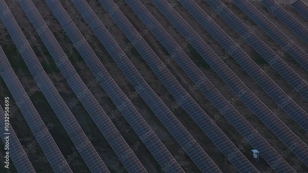Rows of solar panels stretch across the landscape, showcasing a well organized solar energy facility in Lithuania from an aerial perspective. Rows of solar panels stretch across the landscape, showcasing a well organized solar energy facility in Lithuania from an aerial perspective.