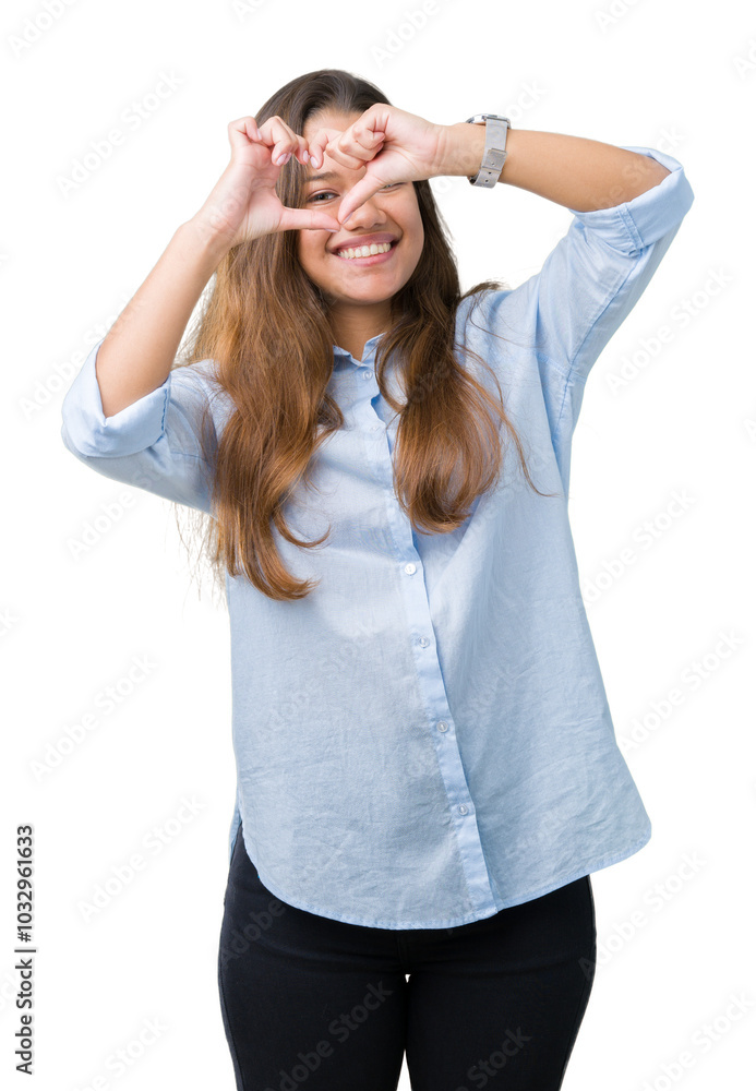 Young beautiful brunette business woman over isolated background Doing heart shape with hand and fingers smiling looking through sign Young beautiful brunette business woman over isolated background Doing heart shape with hand and fingers smiling looking through sign