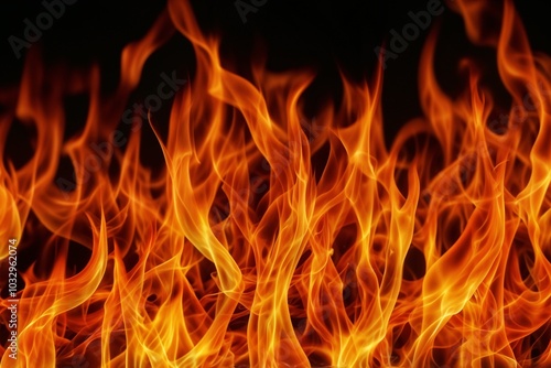 Bright flames burning against a black background, showcasing fire.