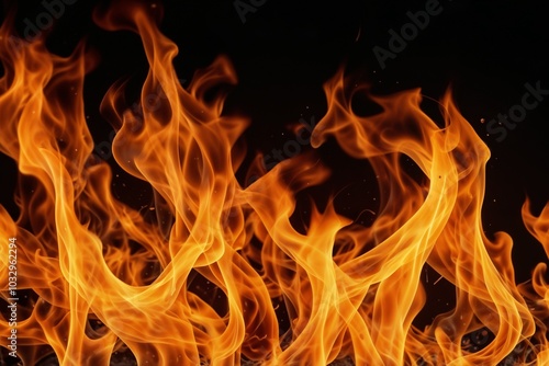 Bright flames burning against a black background, showcasing fire.