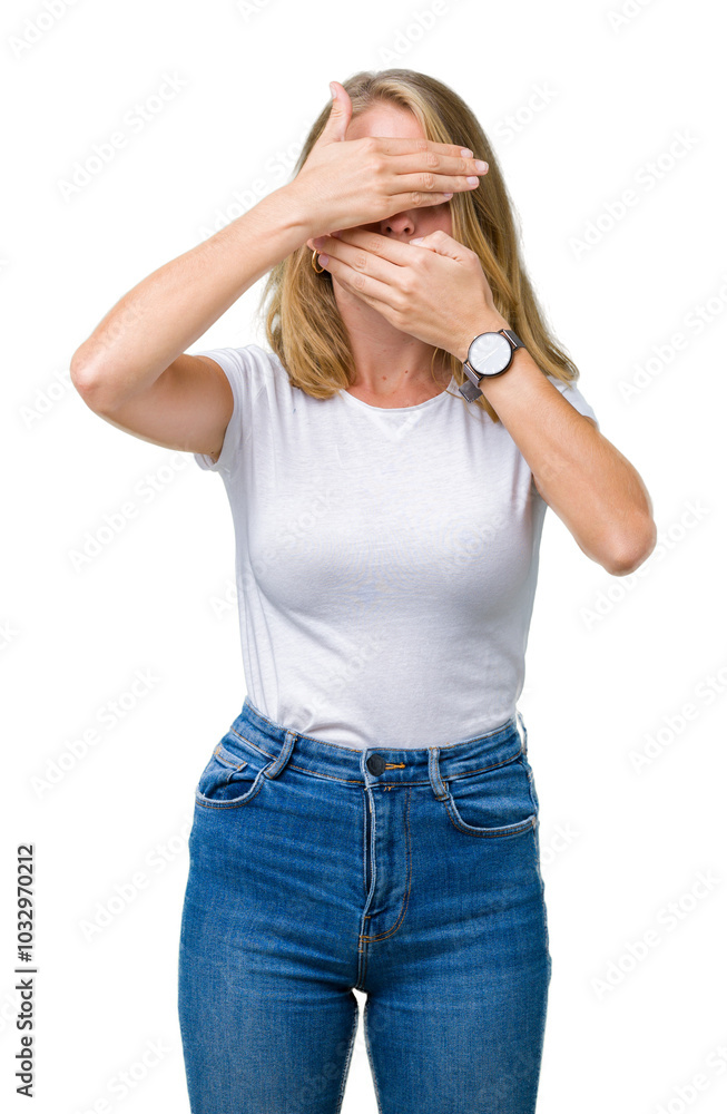 Beautiful young woman wearing casual white t-shirt over isolated background Covering eyes and mouth with hands, surprised and shocked. Hiding emotion Beautiful young woman wearing casual white t-shirt over isolated background Covering eyes and mouth with hands, surprised and shocked. Hiding emotion