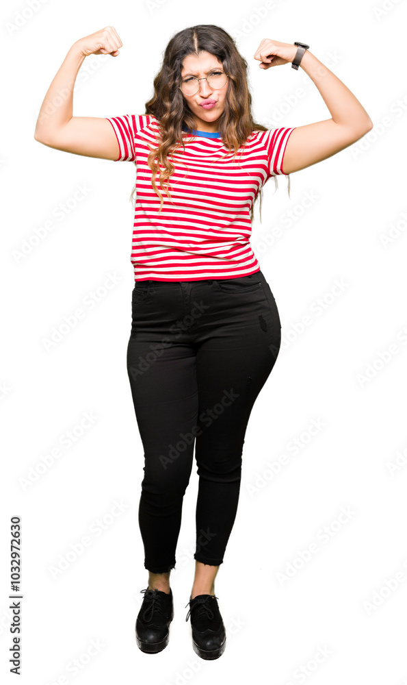 Obraz premium Young beautiful woman wearing glasses showing arms muscles smiling proud. Fitness concept.