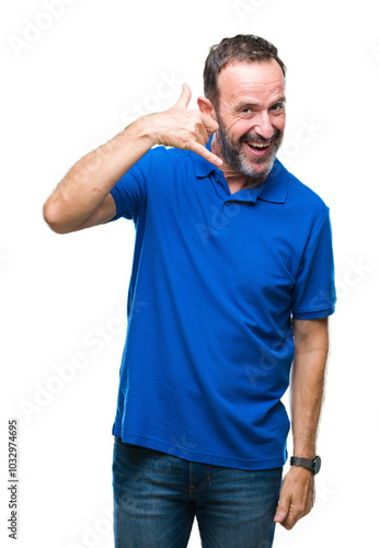 Middle age hoary senior man over isolated background smiling doing phone gesture with hand and fingers like talking on the telephone. Communicating concepts.