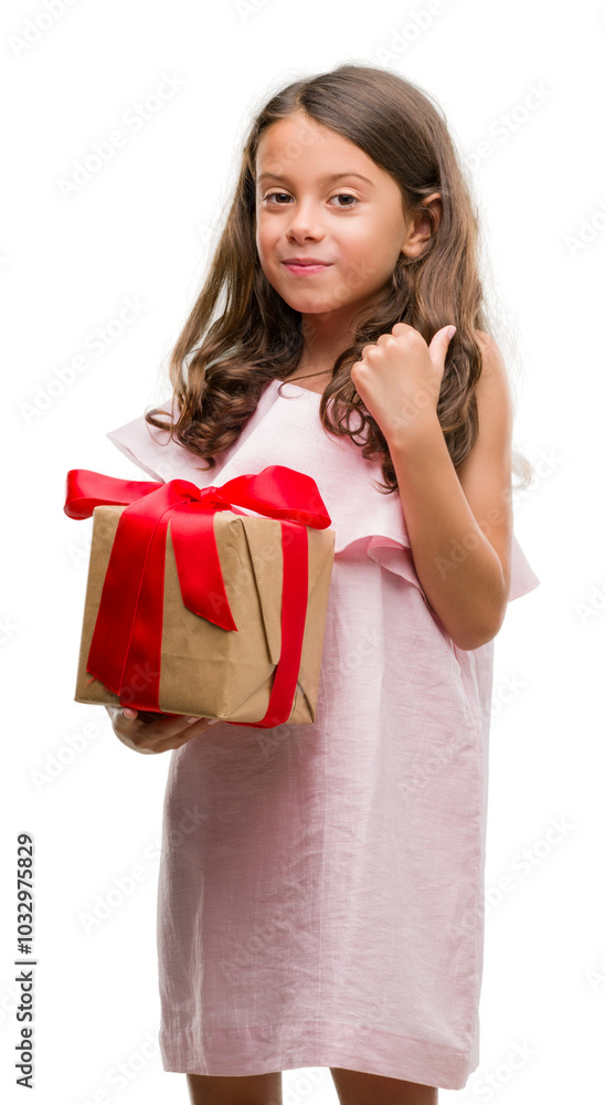 Brunette hispanic girl holding a gift happy with big smile doing ok sign, thumb up with fingers, excellent sign Brunette hispanic girl holding a gift happy with big smile doing ok sign, thumb up with fingers, excellent sign