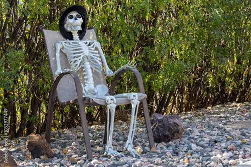 skeleton sitting in chair outside