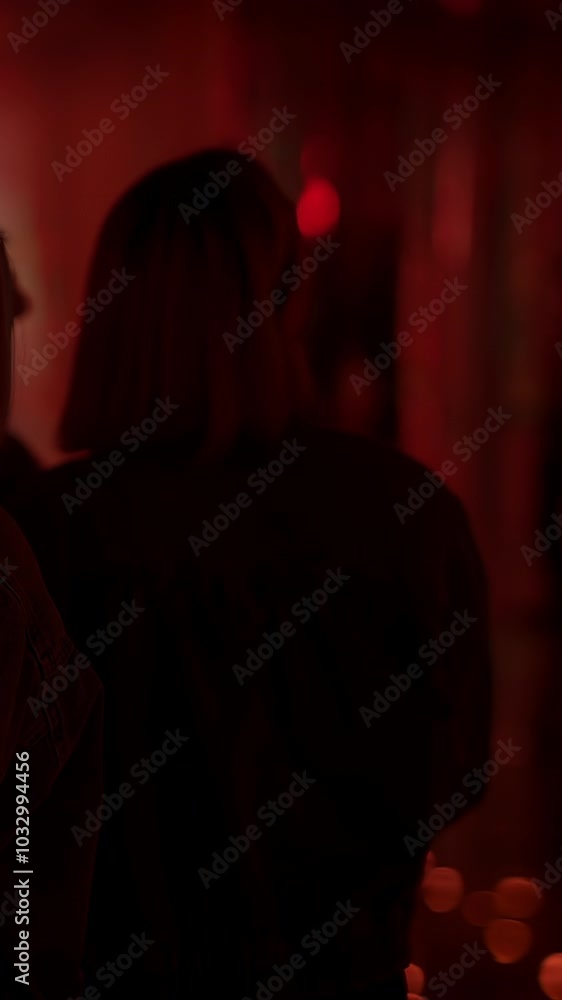 Mysterious Night Out Two Figures Engulfed in a Captivating Red Light That Reveals Intrigue Mysterious Night Out Two Figures Engulfed in a Captivating Red Light That Reveals Intrigue