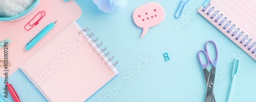 Colorful Stationery Flat Lay with Notebooks and Scissors on a Bright Blue Background photo