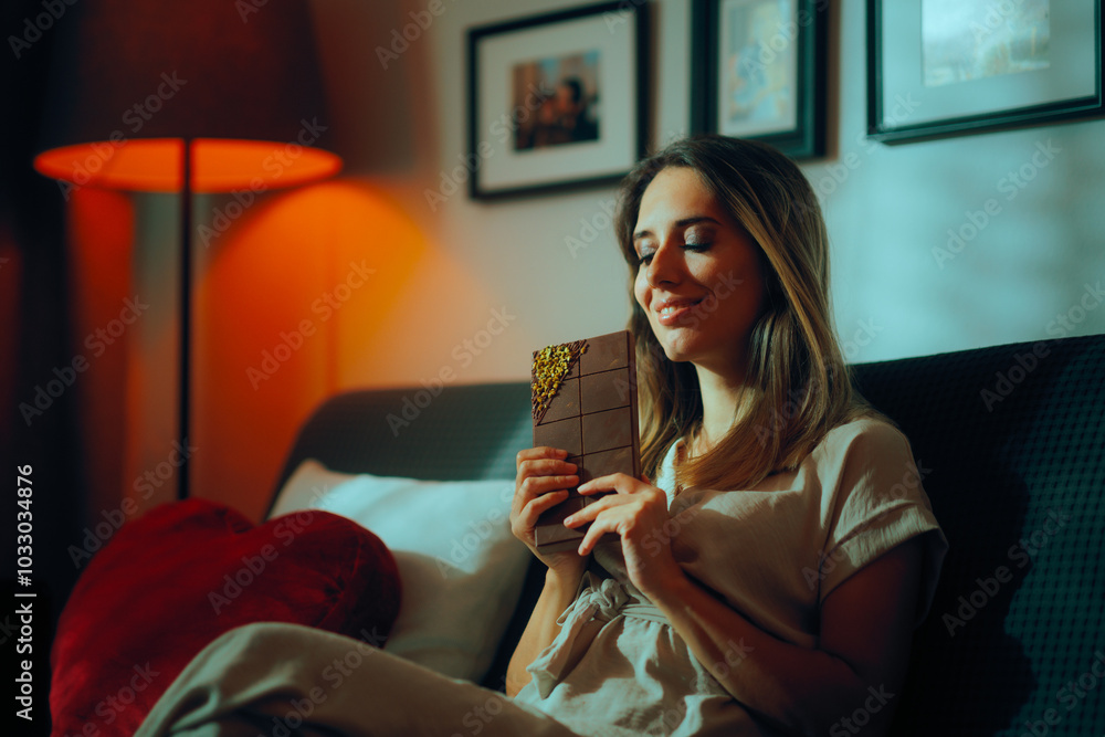 Naklejka premium Woman Holding a Chocolate with Pistachio filling. Happy smiling lady indulging with a huge bar of chocolate 