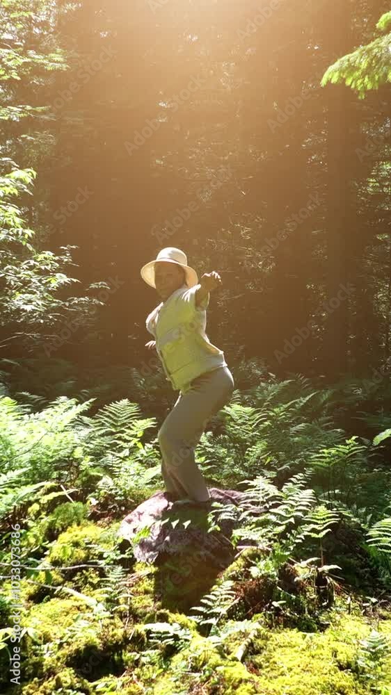 A person enjoys natures beauty, surrounded by bright sunlight and vibrant green ferns A person enjoys natures beauty, surrounded by bright sunlight and vibrant green ferns