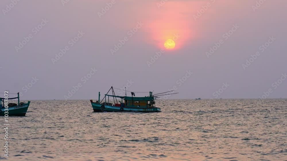 Sunset on the beautiful bay when the fishing boat faces the sun is also the end of the day at the pearl island of Phu Quoc, Vietnam. Sunset on the beautiful bay when the fishing boat faces the sun is also the end of the day at the pearl island of Phu Quoc, Vietnam.