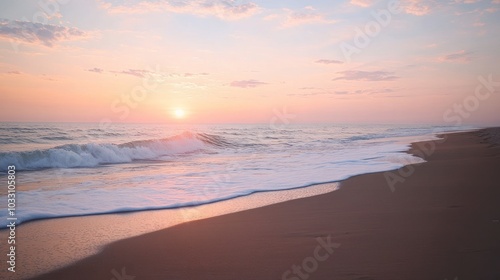 A beautiful sunset over the ocean with waves crashing on the sandy beach.