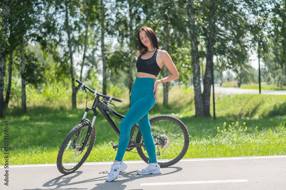 Caucasian woman riding a bike in a park. 