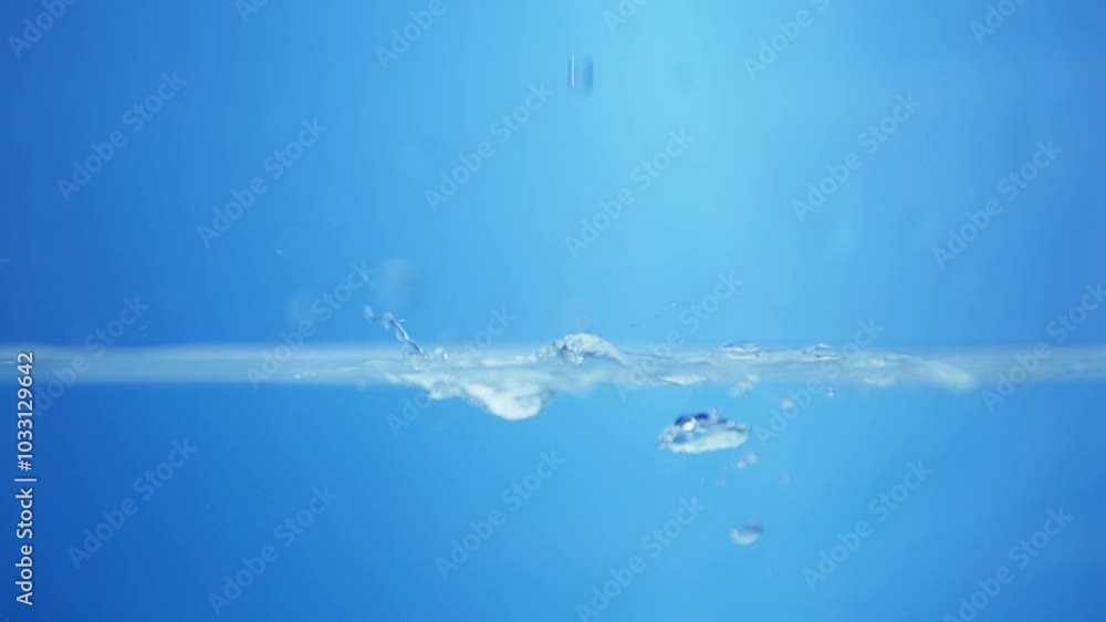 Charming visuals of water's surface, showcasing the soothing qualities and purity of clean drinking water in slow motion. Charming visuals of water's surface, showcasing the soothing qualities and purity of clean drinking water in slow motion.