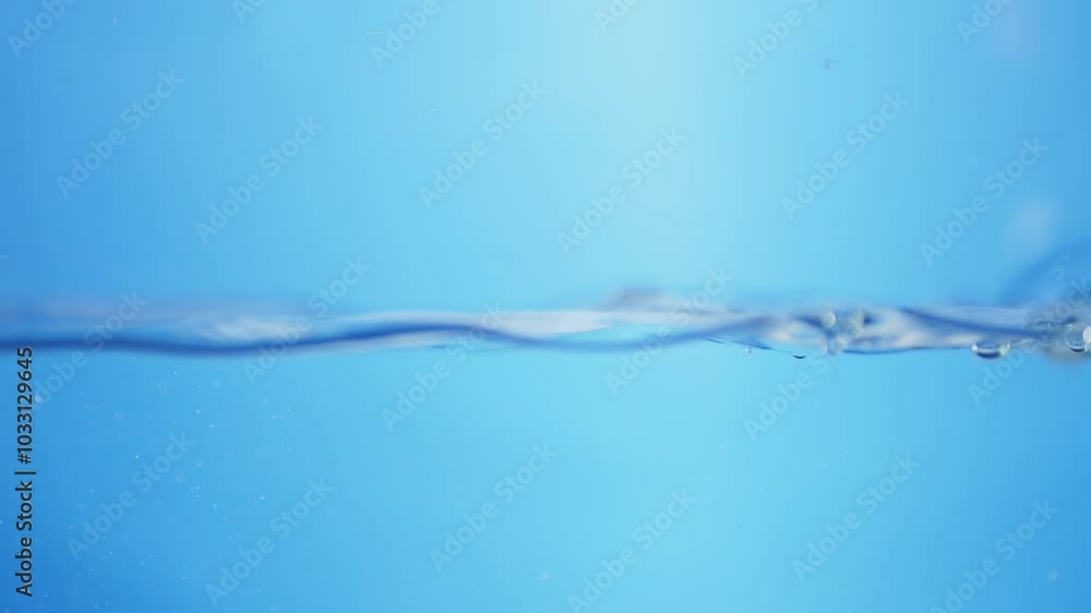 Breathtaking close-up of water in slow motion, capturing the beauty of blue waves and the purity of natural drinking water. Breathtaking close-up of water in slow motion, capturing the beauty of blue waves and the purity of natural drinking water.