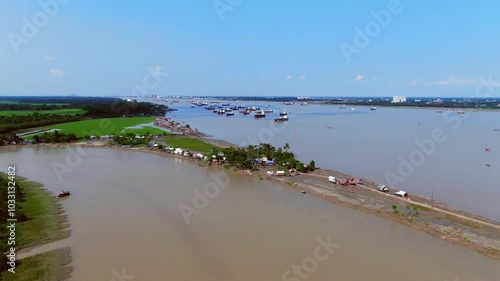 Sundarbans in Bangladesh with scenic beauty. Mongla port with two rivers. Ships in Pashur River and slum. Rampal Power Station. Climate change impacts. People in rural village. 4K Drone footage photo