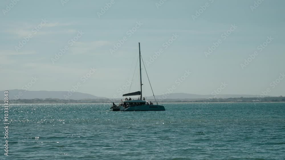 Catamaran Boat With Tourists At Sunrise In Lisbon, Portugal. Wide Shot Catamaran Boat With Tourists At Sunrise In Lisbon, Portugal. Wide Shot