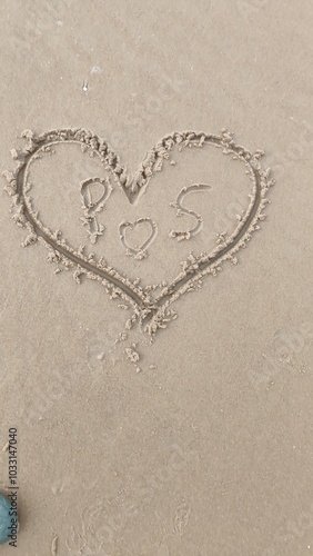 A heart is drawn on the sand on the beach at sunset.Romantic sunset on the beach.Heart shape. Heart symbol.Love.Draw a heart shape on the sandy beach in the morning. to welcome Valentine's Day.