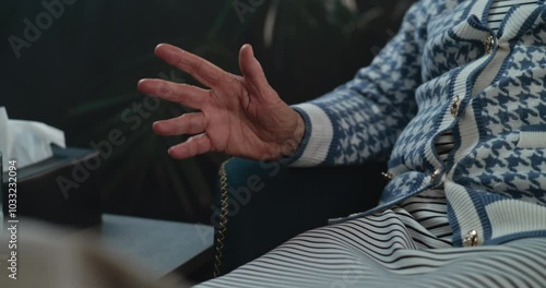 Close up of old female patient gesturing in psychotherapist's office. Elderly woman discusses mental problems, telling therapist about anxious disorder experience. Psychology concept. Portrait.