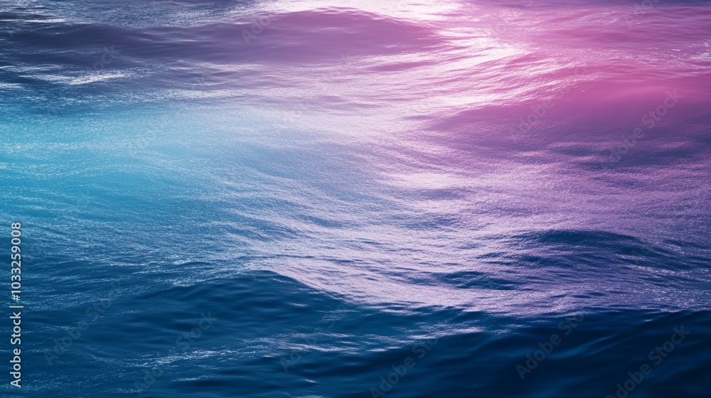 Fototapeta premium A serene ocean surface shimmering with shades of blue and pink, reflecting light and creating a tranquil atmosphere.