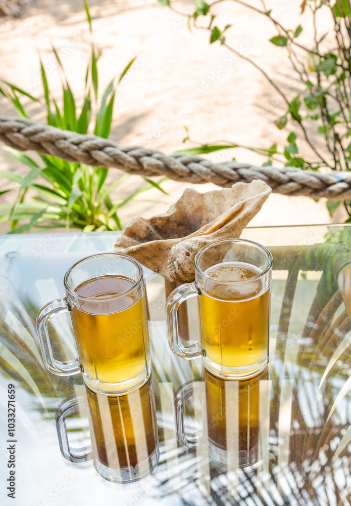 Table with two glasses ofbeer, Labuan Bajo, Ost Nusa Tenggara, Flores, Indonesia, Southeast Asia. Table with two glasses ofbeer, Labuan Bajo, Ost Nusa Tenggara, Flores, Indonesia, Southeast Asia.