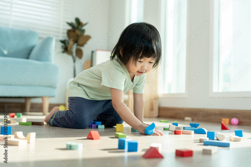 Happy Asian child playing and learning toy blocks. children are very happy and excited at home. child have a great time playing, activities, development, attention deficit hyperactivity disorder Happy Asian child playing and learning toy blocks. children are very happy and excited at home. child have a great time playing, activities, development, attention deficit hyperactivity disorder
