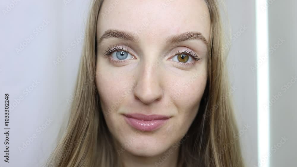 Heterochromia is a unique natural phenomenon in a young, beautiful woman. Close-up of female face. The girl is genuinely smiling and looking at the camera. Natural beauty, eyes of different colors Heterochromia is a unique natural phenomenon in a young, beautiful woman. Close-up of female face. The girl is genuinely smiling and looking at the camera. Natural beauty, eyes of different colors