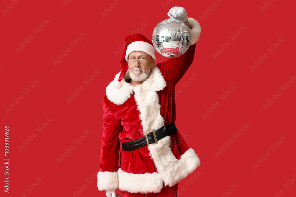 Santa Claus in glasses with disco ball on red background Santa Claus in glasses with disco ball on red background