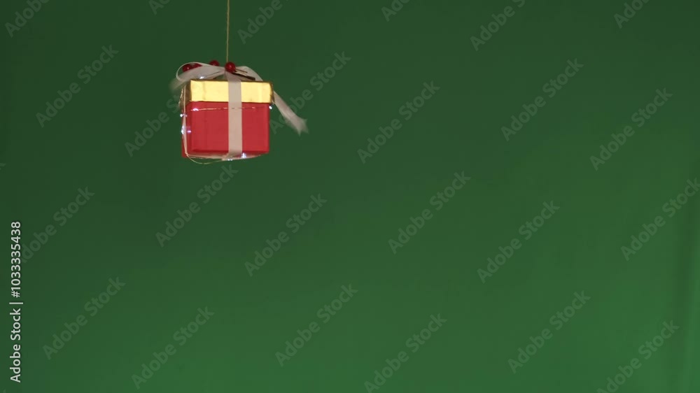 Santa hand launching drone with red Christmas gift, on green background. Copy space. Santa hand launching drone with red Christmas gift, on green background. Copy space.