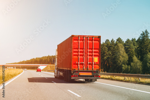 Red container truck moving on the freeway