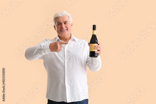 Senior man with bottle of c...