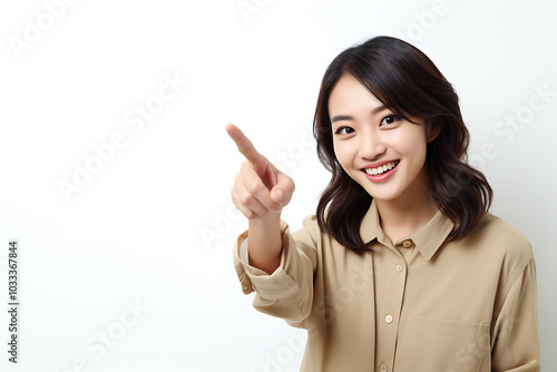 Smiling woman pointing to empty space, expressing excitement and positivity