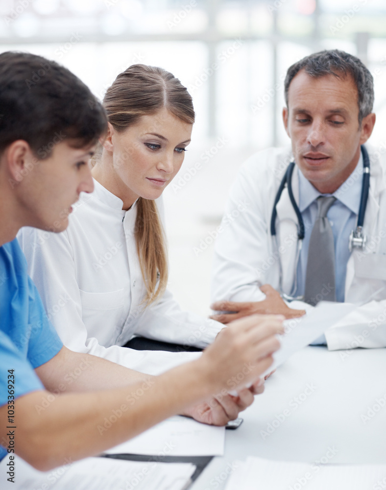 Doctors, group and meeting with paperwork at hospital with review, report or career in healthcare. Person, medic and scrum in boardroom at clinic for wellness, services and documentation for feedback Doctors, group and meeting with paperwork at hospital with review, report or career in healthcare. Person, medic and scrum in boardroom at clinic for wellness, services and documentation for feedback