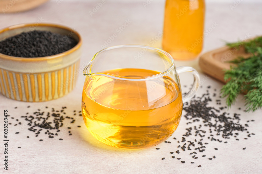 Jug of oil with sesame seeds on white background Jug of oil with sesame seeds on white background