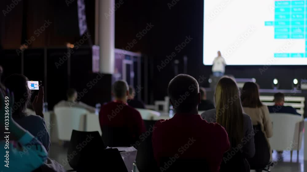 Speaker man with microphone at seminar audience at stage, business people, conference, meeting, congress, coach, speaker, business forum, training, seminar, speech person about management, economics Speaker man with microphone at seminar audience at stage, business people, conference, meeting, congress, coach, speaker, business forum, training, seminar, speech person about management, economics