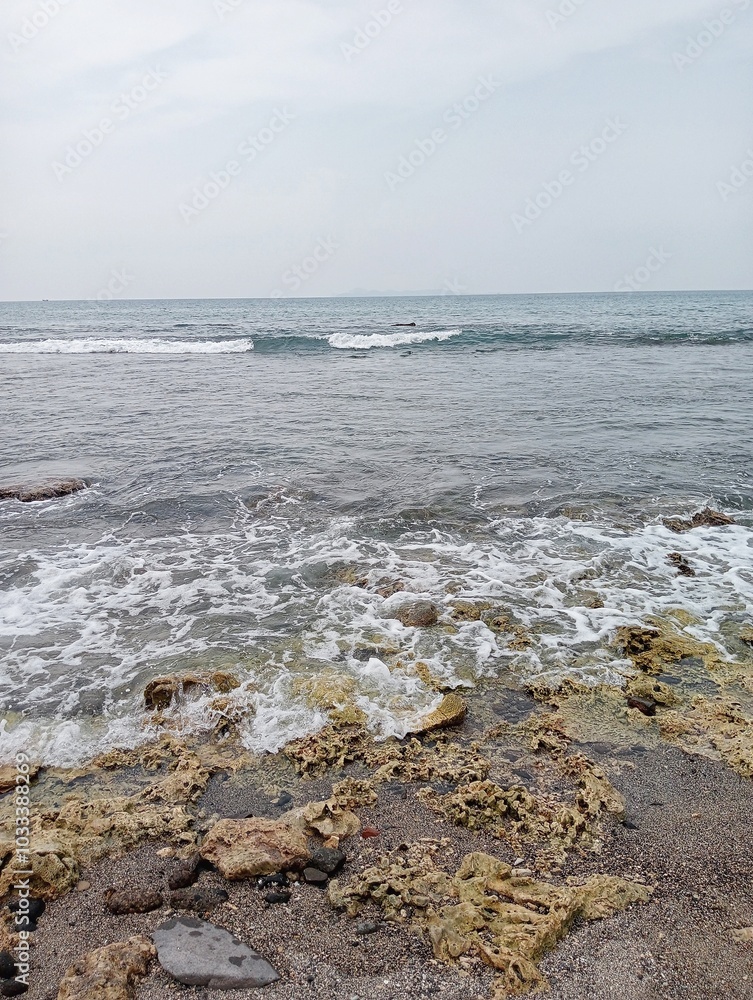 Waves crashing against the rocks on the shore Waves crashing against the rocks on the shore