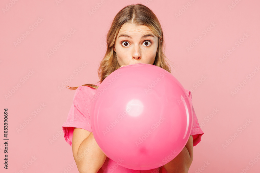 Young shocked surprised cheerful woman wear shirt celebrating birthday holiday and blowing big air balloon look camera isolated on plain pastel light pink background studio portrait Lifestyle concept Young shocked surprised cheerful woman wear shirt celebrating birthday holiday and blowing big air balloon look camera isolated on plain pastel light pink background studio portrait Lifestyle concept