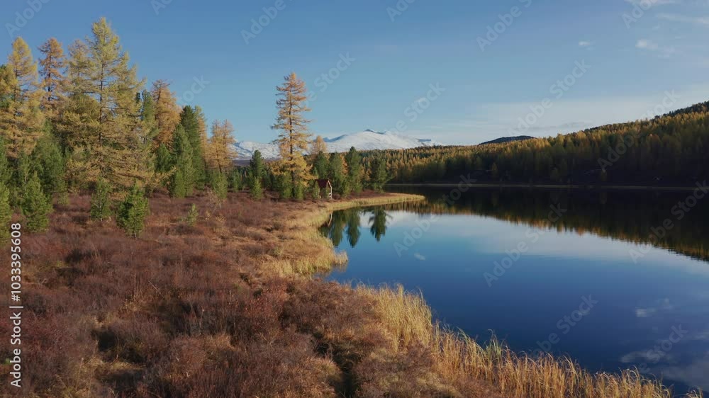 Captured by drone, this stunning image showcases Mountain Altai's autumnal landscape. Snow-capped mountains and a serene lake accentuate the area's natural beauty during the late autumn season. Captured by drone, this stunning image showcases Mountain Altai's autumnal landscape. Snow-capped mountains and a serene lake accentuate the area's natural beauty during the late autumn season.