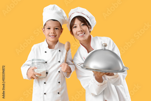 Female Asian chef with cloc...
