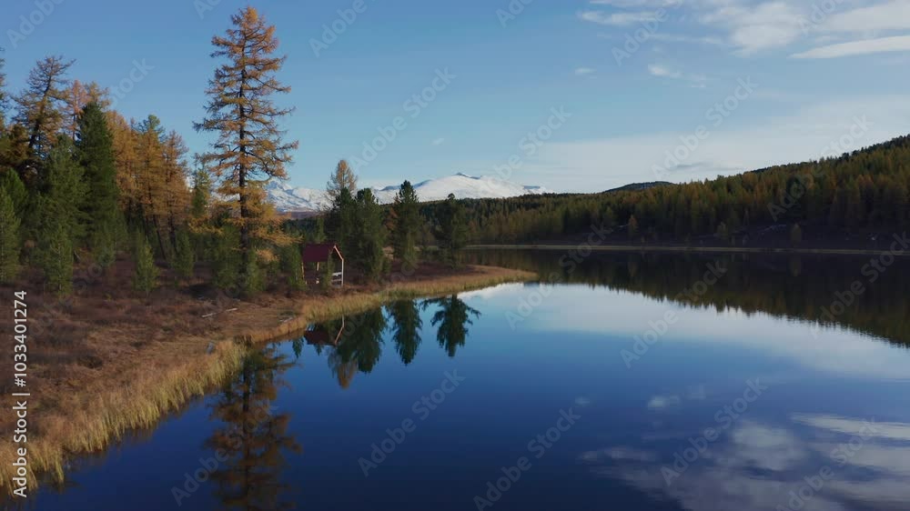 Breathtaking drone view of Mountain Altai in late autumn, capturing snow-capped peaks and clear lake reflections. The landscape reveals vibrant fall colors and serene natural beauty from above. Breathtaking drone view of Mountain Altai in late autumn, capturing snow-capped peaks and clear lake reflections. The landscape reveals vibrant fall colors and serene natural beauty from above.