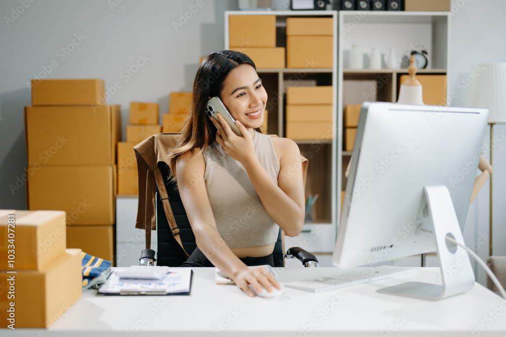 Young business owner woman prepare parcel box and standing check online orders for deliver Young business owner woman prepare parcel box and standing check online orders for deliver