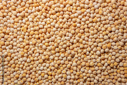 Uncooked Yellow Polished Peas Background. A Culinary Canvas of Dry Yellow Peas, Creating a Lively and Textured Background for Gourmet Cooking. Scattered Raw Polished Peas. Healthy Eating Ingredients