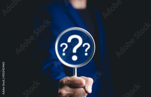 Question mark, Problem solving and analysis concept. Businessman holds magnifying glass focused on question mark, analysis, problem solving, identifying cause of issues during work process, solution,