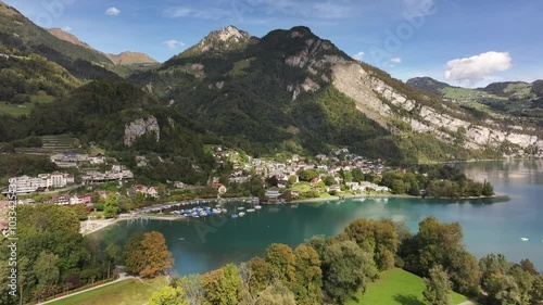 Lake Walen Backdropped By Lush Green Swiss Alps In Weesen, Canton of St. Gallen, Switzerland. wide drone shot photo