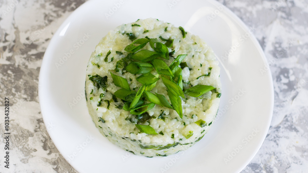 Vegan, vegetarian delicious dish. Rice with spinach on a white plate Vegan, vegetarian delicious dish. Rice with spinach on a white plate