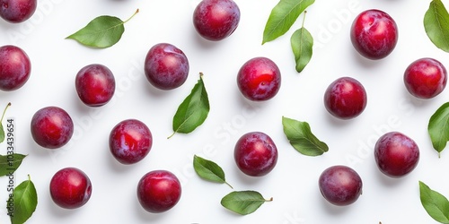 Summer harvest of red plums. Red plums and leaves pattern on a white background top view with space for text. photo